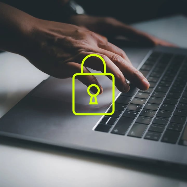 A person working on a laptop displaying a padlock icon, symbolizing security and privacy in digital activities.