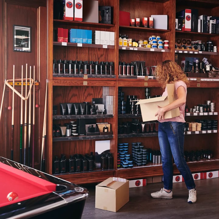 A woman receiving a beauty treatment in a salon, surrounded by professional equipment and a serene atmosphere.