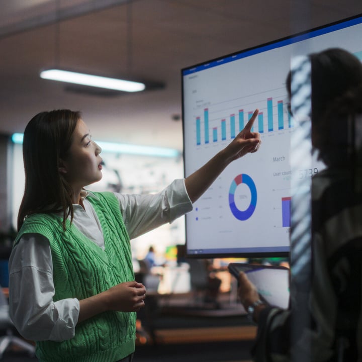 A women looking at a computer screen looking at a visual of data